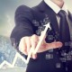 Businessman Touching a Graph Indicating Growth